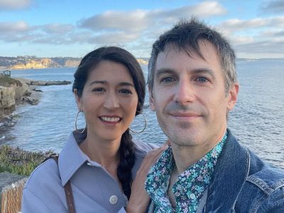 Nick Sylvester is taking a selfie with Mina Kimes with ocean in the background.